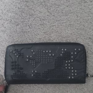 Mcm studded wallet with embroidered lion.